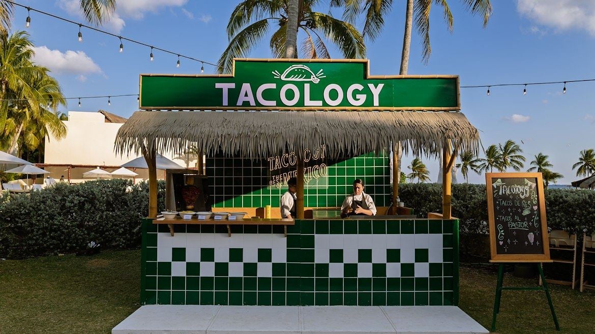 A man standing at a taco stand