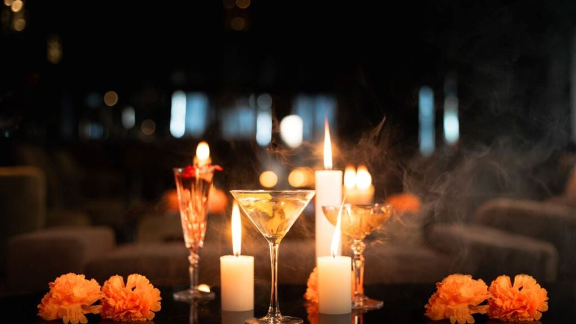 A group of glasses with flowers and candles